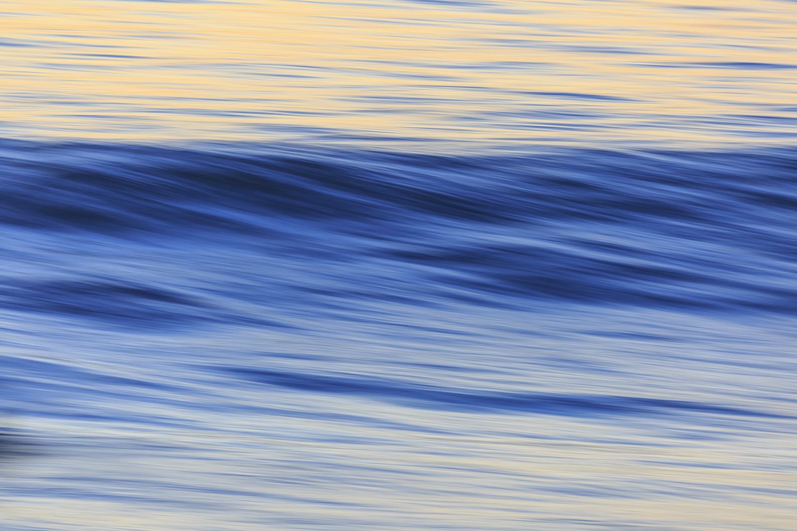 Blue ocean swell at dusk, softened by a long exposure